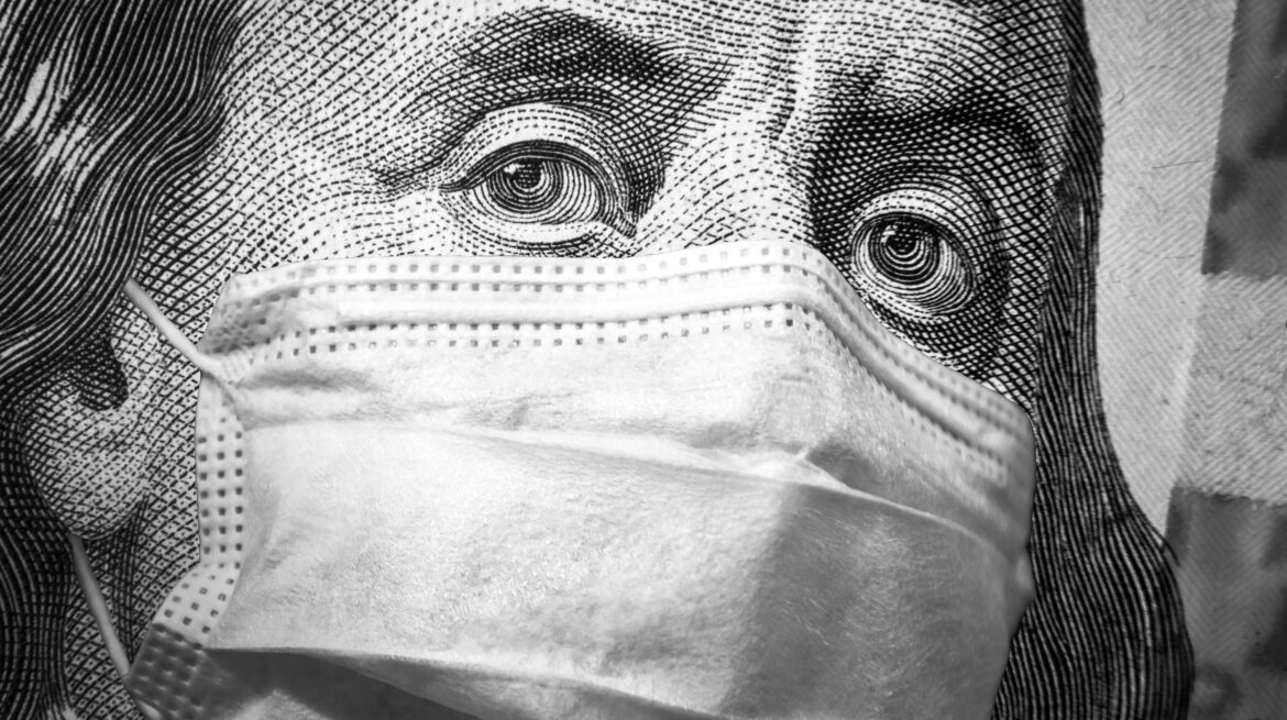 COVID-19 coronavirus, finance and crisis concept, US president Franklin`s eyes and face mask on 100 dollar money bill. Corona virus affects global stock market. World economy hit by pandemic fears.