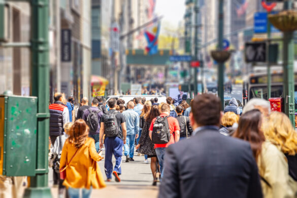 USA, New York, Manhattan streets. Skyscrapers and crowded streets, cars and busy people walking downtown in a spring sunny day